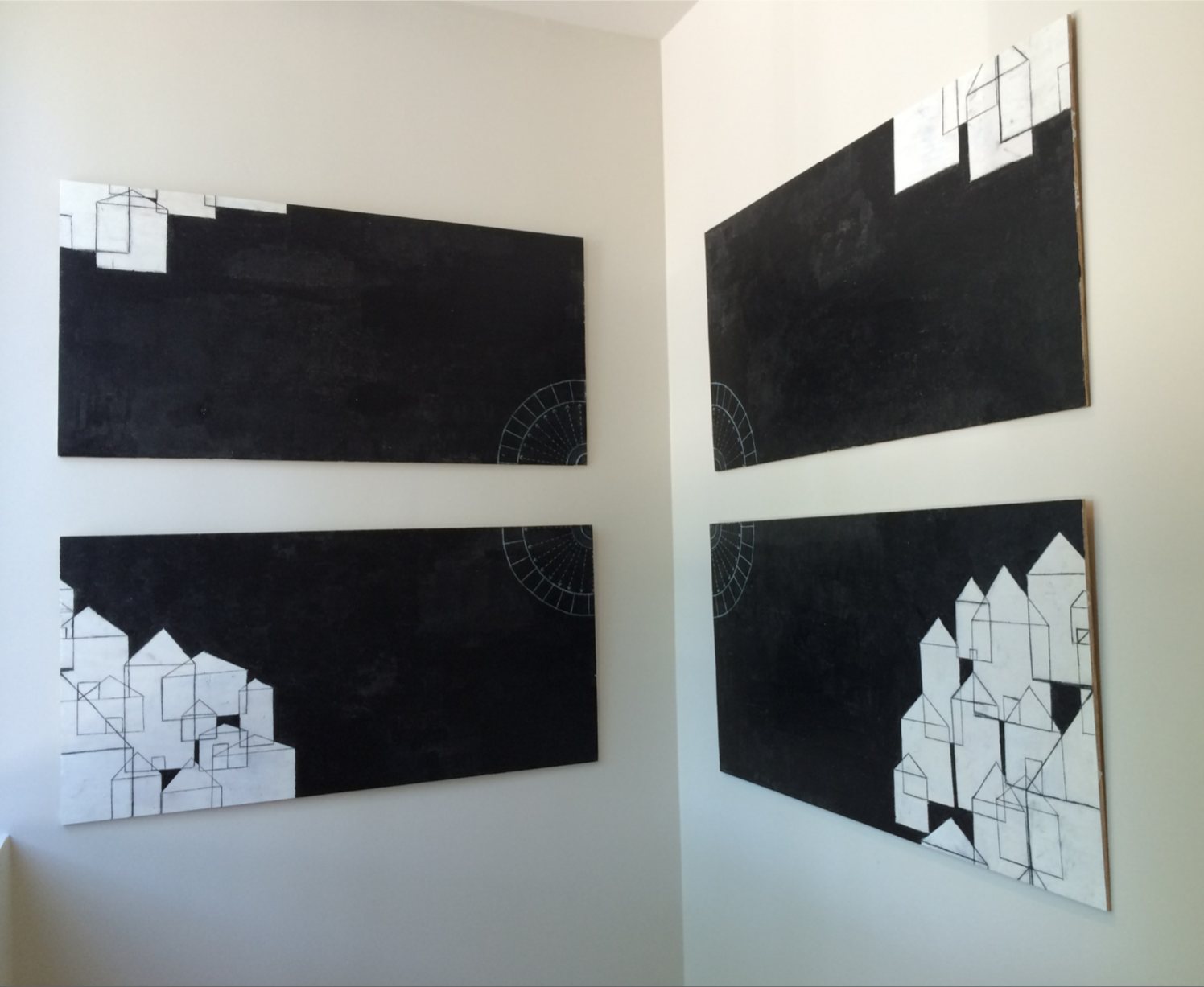 Four black panels hung in the corner of a white room. White house shapes gather in the outer corners; the arcs of a panopticon sit where the panels meet.